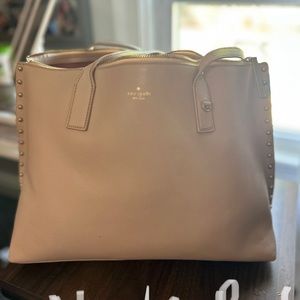 Kate spade tote, has zipper top, gold grommet sides. Looks brand new